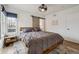 Lovely main bedroom boasts a large window with natural light and wood floors at 4504 N Clay St, Denver, CO 80211