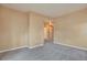 Neutral bedroom featuring carpeted floor, hallway access, and tan walls at 9429 Ashbury Cir # 101, Parker, CO 80134