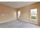 Neutral bedroom featuring carpeted floor, two windows, and tan walls at 9429 Ashbury Cir # 101, Parker, CO 80134