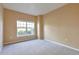 Bright bedroom featuring a large window, carpeted floor, and neutral paint at 9429 Ashbury Cir # 101, Parker, CO 80134