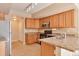 Well-lit kitchen features wood cabinetry, tile floors and an efficient layout at 9429 Ashbury Cir # 101, Parker, CO 80134