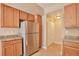 Functional kitchen with stainless steel appliances, wooden cabinets, and a well-lit interior at 9429 Ashbury Cir # 101, Parker, CO 80134