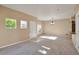 Bright living room featuring neutral walls, plush carpeting, and an abundance of natural light at 9429 Ashbury Cir # 101, Parker, CO 80134