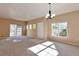 Inviting living area featuring a modern light fixture, plush carpet, and ample natural light at 9429 Ashbury Cir # 101, Parker, CO 80134