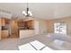 Spacious living room with a modern chandelier, plush carpeting, and access to a private balcony at 9429 Ashbury Cir # 101, Parker, CO 80134