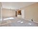 Open-concept living area showcasing neutral decor, carpet flooring, and seamless transition to the kitchen at 9429 Ashbury Cir # 101, Parker, CO 80134