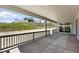 Covered back porch features concrete flooring and views of the grassy surroundings at 1694 Fox Trotter Pt, Castle Rock, CO 80104