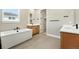 Bright bathroom with a soaking tub, double vanity, and a walk-in closet at 1694 Fox Trotter Pt, Castle Rock, CO 80104