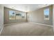 Empty bedroom with neutral paint, beige carpet, and many windows providing lots of natural light at 1694 Fox Trotter Pt, Castle Rock, CO 80104