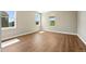 Sunny bedroom with wood floors and large windows at 1694 Fox Trotter Pt, Castle Rock, CO 80104