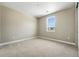 Carpeted bedroom with a view of the community outside the window and neutral walls at 1694 Fox Trotter Pt, Castle Rock, CO 80104