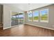 Bright dining room with wood floors, chandelier, and sliding glass doors at 1694 Fox Trotter Pt, Castle Rock, CO 80104