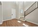 Bright entryway with a staircase, wood floors and a modern front door at 1694 Fox Trotter Pt, Castle Rock, CO 80104