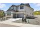Side view of the two-story home with an attached two car garage, and well-maintained yard at 1694 Fox Trotter Pt, Castle Rock, CO 80104