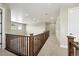 Second floor hallway with wood railing overlooking the home's foyer at 1694 Fox Trotter Pt, Castle Rock, CO 80104
