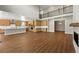 Open concept kitchen with a large island, hardwood floors, and wood cabinets at 1694 Fox Trotter Pt, Castle Rock, CO 80104