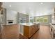 Open-concept kitchen with hardwood floors, a center island, and recessed lighting at 1694 Fox Trotter Pt, Castle Rock, CO 80104