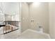 Utility room with tile flooring, access to second floor and laundry hookups at 1694 Fox Trotter Pt, Castle Rock, CO 80104