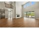 Spacious living room with a fireplace, wood floors and tall windows at 1694 Fox Trotter Pt, Castle Rock, CO 80104