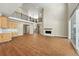 Spacious living room featuring a fireplace, high ceilings, and hardwood floors and access to the balcony at 1694 Fox Trotter Pt, Castle Rock, CO 80104