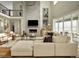 Living room area with hardwood floors, modern fireplace, large comfortable seating and decor at 1694 Fox Trotter Pt, Castle Rock, CO 80104