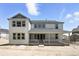 Two-story home featuring a cozy, covered back porch and well-placed windows at 1694 Fox Trotter Pt, Castle Rock, CO 80104