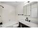 Well-lit bathroom featuring a shower-tub combo and vanity with white countertop and black hardware at 3090 S Telluride St, Aurora, CO 80013