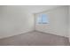 Bright, empty bedroom with neutral carpet and large window offering plenty of natural light at 3090 S Telluride St, Aurora, CO 80013