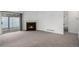 Spacious living room featuring plush carpet, a fireplace, and sliding glass doors to the outdoor patio at 3090 S Telluride St, Aurora, CO 80013