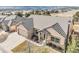 An aerial view of a beautiful home featuring a stone facade, tile roof, and three car garage at 1520 Symphony Hts, Monument, CO 80132