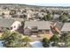 Expansive aerial shot of a home showcasing its backyard, neighboring properties, and community layout at 1520 Symphony Hts, Monument, CO 80132