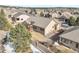 Aerial view of a home with a covered patio, nestled in a neighborhood with mature trees and landscaping at 1520 Symphony Hts, Monument, CO 80132