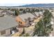 Aesthetic aerial view of a house with a backyard patio, showcasing community landscaping and street layout at 1520 Symphony Hts, Monument, CO 80132