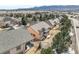 Overhead view of a residence surrounded by lush greenery, illustrating its serene setting and neighborhood design at 1520 Symphony Hts, Monument, CO 80132