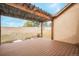 Inviting covered back patio with wood deck and pergola overlooking the yard at 1520 Symphony Hts, Monument, CO 80132