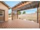 Inviting covered back patio with wood deck and pergola overlooking the yard at 1520 Symphony Hts, Monument, CO 80132