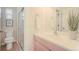 This bathroom offers a glass enclosed shower, white sink and vanity, plus a well-lit mirror at 1520 Symphony Hts, Monument, CO 80132