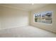 Bright, carpeted bedroom with large window offering a neighborhood view at 1520 Symphony Hts, Monument, CO 80132