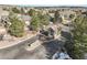 Elegant community entrance with stone signage and a gatehouse, surrounded by mature trees and landscaping at 1520 Symphony Hts, Monument, CO 80132