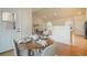 Inviting dining area with wood floors, an archway, a round table, and easy access to living spaces at 1520 Symphony Hts, Monument, CO 80132