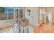 Bright dining area with wood floors, big windows with outdoor view, door with outside access at 1520 Symphony Hts, Monument, CO 80132