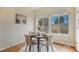 Bright dining area features wood floors, windows with outside views, and a round table for meals at 1520 Symphony Hts, Monument, CO 80132