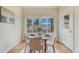 Bright dining room boasts wood floors, windows offering outdoor views, and a door for easy access at 1520 Symphony Hts, Monument, CO 80132