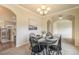 Cozy dining room with a chandelier and black wooden furniture opens to the living area, creating an inviting space at 1520 Symphony Hts, Monument, CO 80132