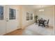 Charming dining area with a decorative front door, window, and stylish chandelier and a view of the front exterior at 1520 Symphony Hts, Monument, CO 80132