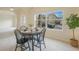 The dining room boasts an arched doorway and a bright window, perfect for entertaining, enhanced by a potted Fiddle Leaf Fig at 1520 Symphony Hts, Monument, CO 80132