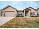 Charming single-Gathering home with a two-car garage, stone accents, and well-maintained lawn at 1520 Symphony Hts, Monument, CO 80132