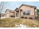 Beautiful home featuring a stone accent facade, tile roof, and manicured front yard at 1520 Symphony Hts, Monument, CO 80132