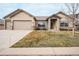Beautiful home featuring a stone accent facade, tile roof, and manicured front yard at 1520 Symphony Hts, Monument, CO 80132