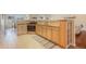 Bright kitchen with a breakfast bar, wooden cabinetry, and ample counter space at 1520 Symphony Hts, Monument, CO 80132